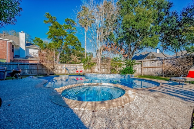 view of pool featuring a patio area and an in ground hot tub