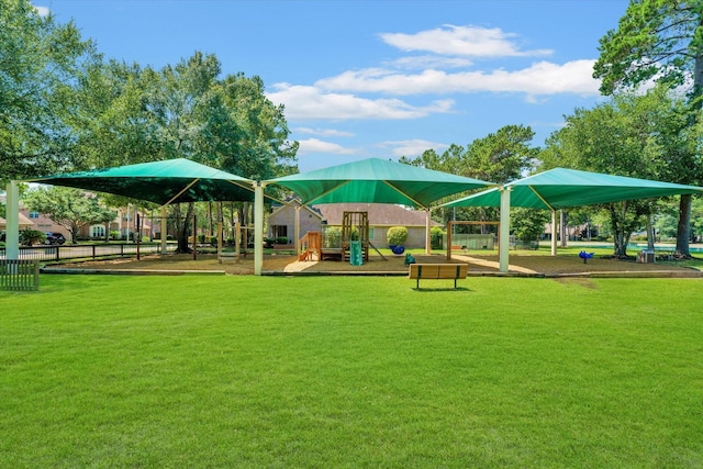 view of property's community featuring a playground and a lawn