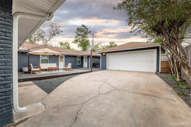 view of front of property with a garage, an outdoor hangout area, and a deck