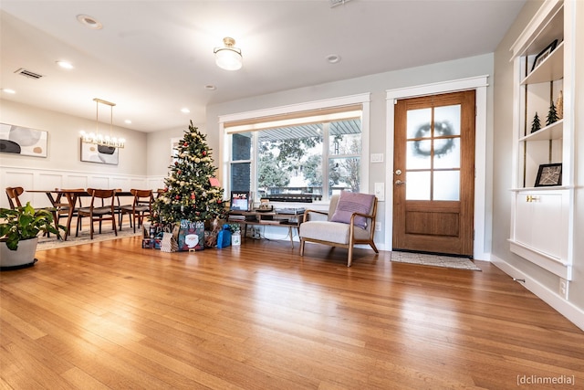 interior space with a notable chandelier and light hardwood / wood-style floors