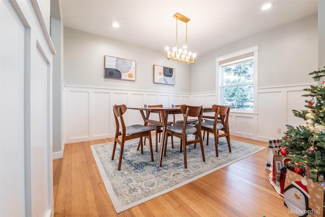 dining area featuring a chandelier and light hardwood / wood-style flooring