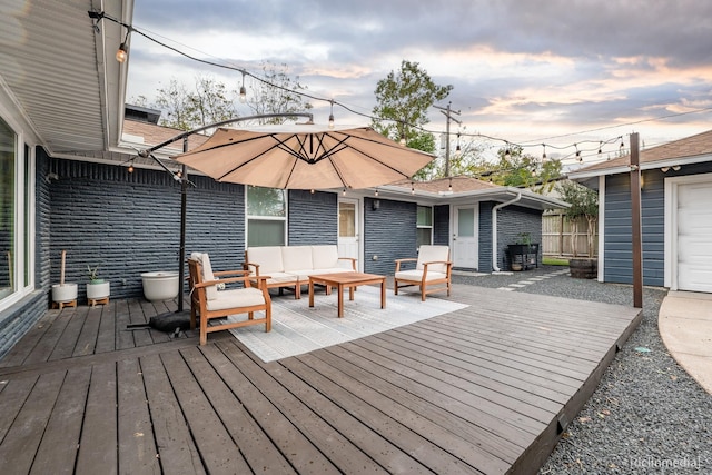 deck at dusk with outdoor lounge area