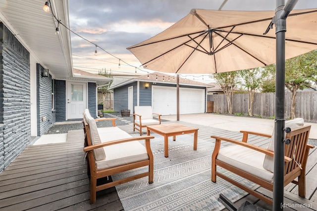 wooden terrace with a garage and an outdoor structure