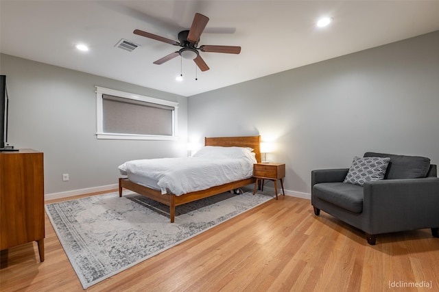 bedroom with ceiling fan and light hardwood / wood-style floors