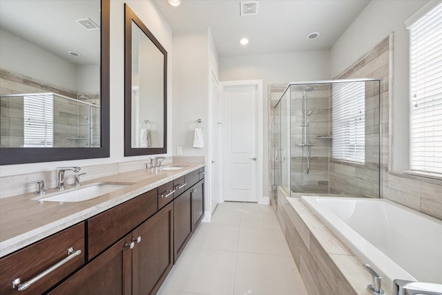 bathroom with plenty of natural light, tile patterned floors, and vanity