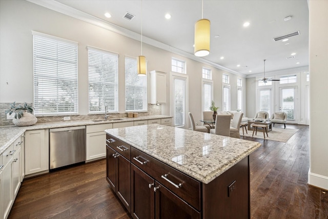 kitchen featuring dishwasher, hanging light fixtures, sink, dark brown cabinets, and ceiling fan