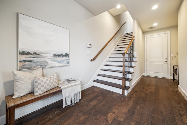 staircase with hardwood / wood-style floors