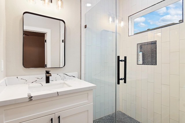 bathroom featuring vanity and a shower with shower door