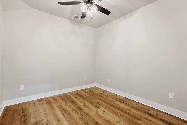 empty room featuring ceiling fan, lofted ceiling, and hardwood / wood-style flooring