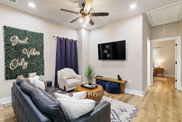 living room with light hardwood / wood-style floors and ceiling fan