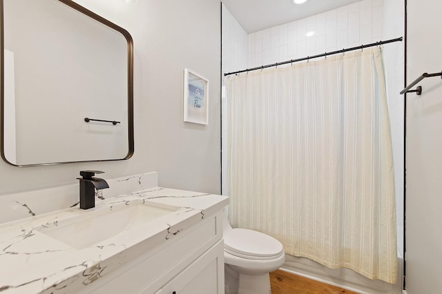 full bathroom with shower / tub combo, vanity, and toilet