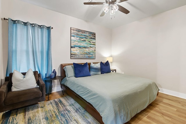 bedroom with wood-type flooring and ceiling fan