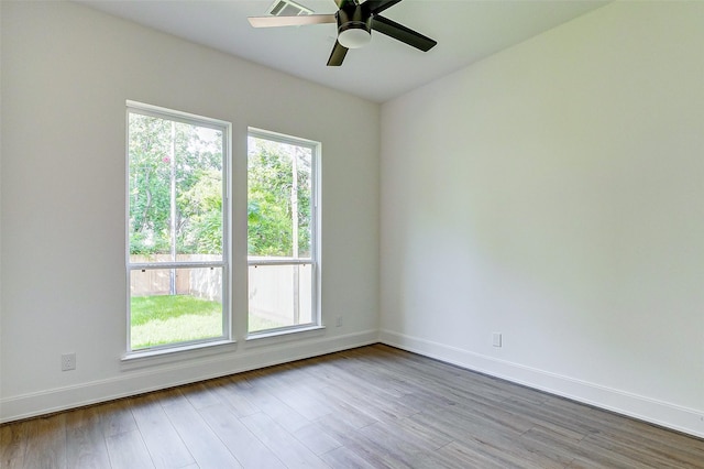 empty room with light hardwood / wood-style flooring and ceiling fan