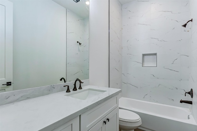 full bathroom with vanity, toilet, and tiled shower / bath