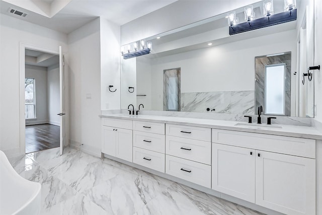 bathroom featuring vanity and a tub