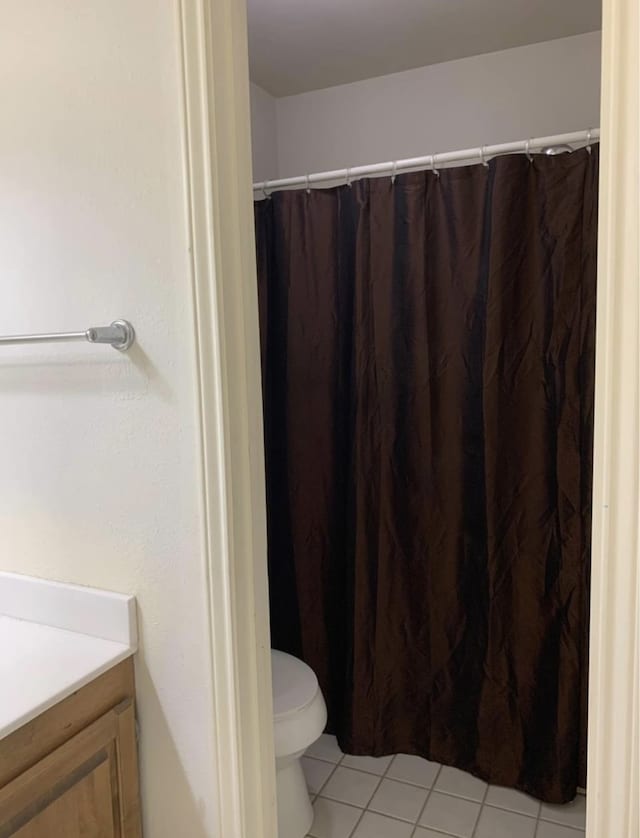 bathroom with tile patterned floors, vanity, and toilet