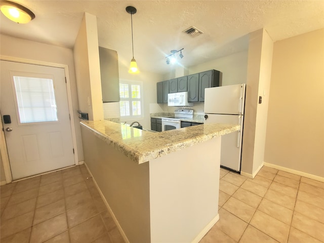 kitchen featuring visible vents, white appliances, light tile patterned flooring, and a peninsula