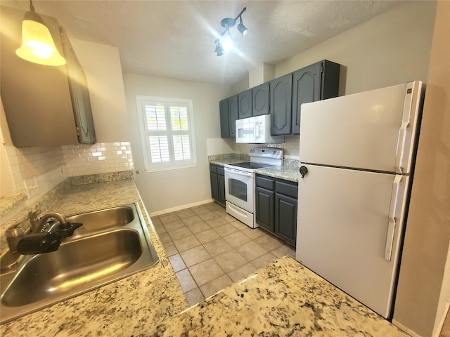 kitchen featuring light countertops, tasteful backsplash, a sink, and white appliances
