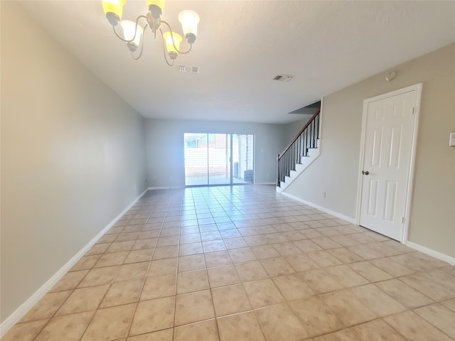 2030 Plantation Dr Unit B-2, Conroe, TX 77301 - empty room featuring a chandelier, stairway, baseboards, and light tile patterned floors