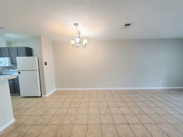 2030 Plantation Dr Unit B-2, Conroe, TX 77301 - unfurnished dining area featuring a chandelier, baseboards, and a textured ceiling