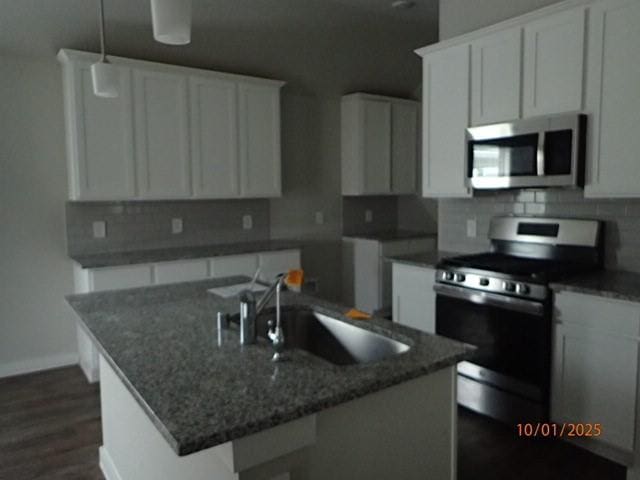 kitchen with sink, white cabinetry, an island with sink, and appliances with stainless steel finishes