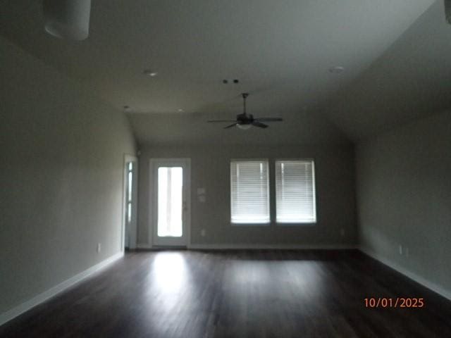 interior space with ceiling fan, dark hardwood / wood-style flooring, and vaulted ceiling