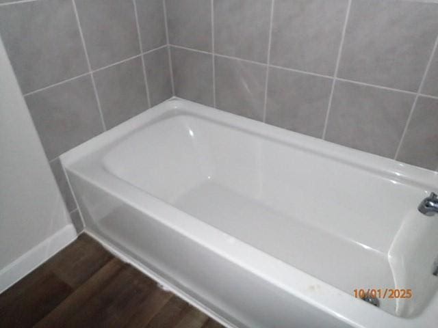 bathroom featuring a washtub and wood-type flooring