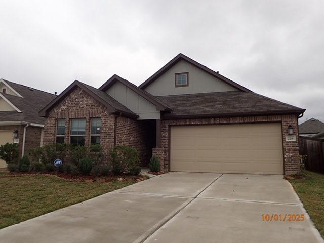 view of front of house with a garage and a front lawn