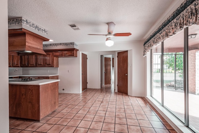 kitchen featuring ceiling fan, black electric stovetop, light tile patterned flooring, and a textured ceiling