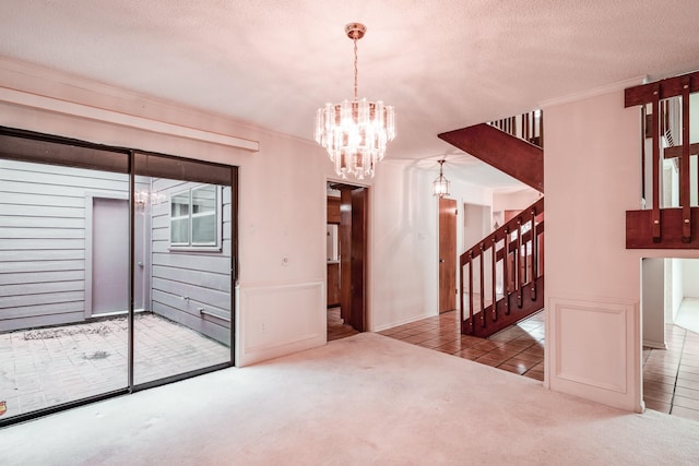 interior space with light colored carpet, a textured ceiling, and an inviting chandelier