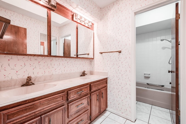 bathroom with tile patterned flooring, vanity, and tiled shower / bath