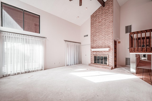 unfurnished living room with high vaulted ceiling, carpet flooring, a fireplace, ceiling fan, and beamed ceiling