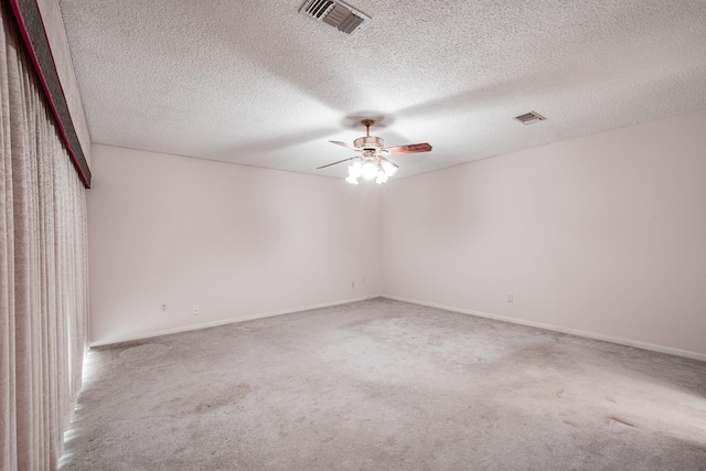 unfurnished room featuring a textured ceiling, ceiling fan, and carpet