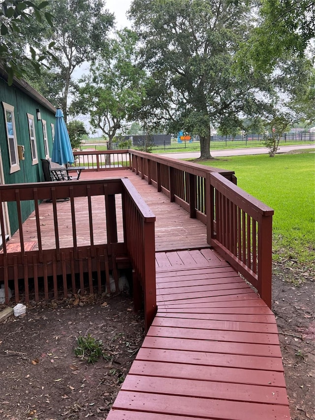 wooden deck with a lawn