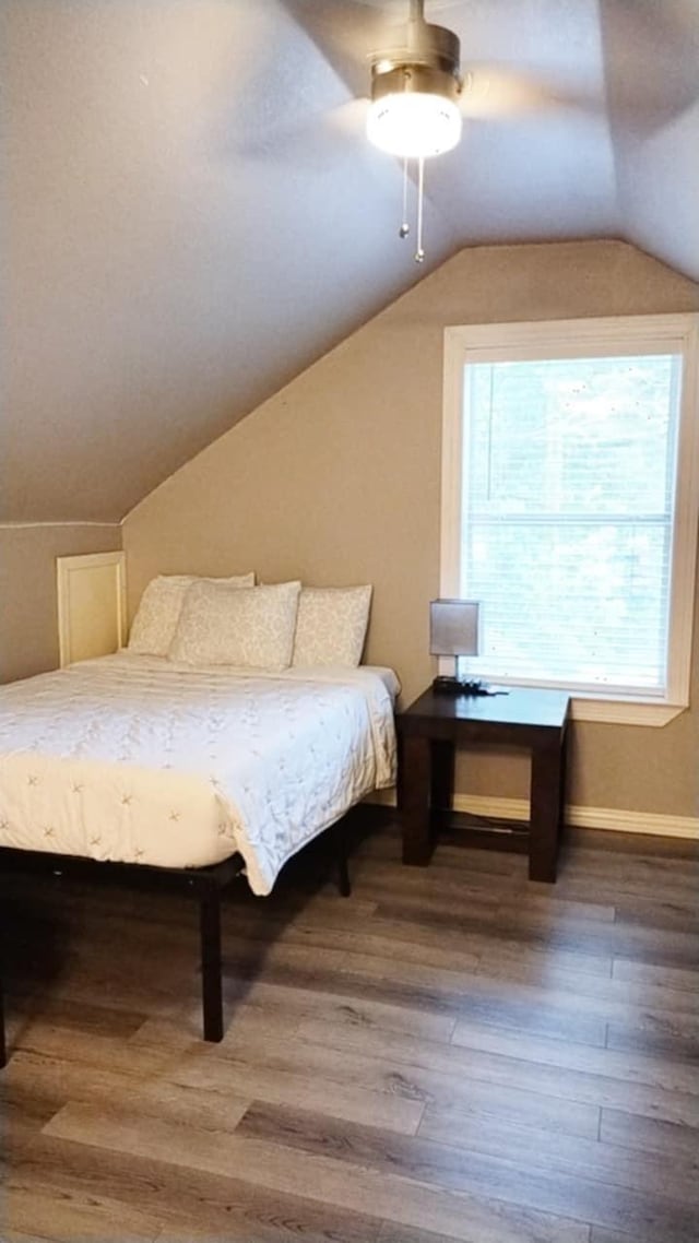 bedroom with hardwood / wood-style floors, ceiling fan, and lofted ceiling