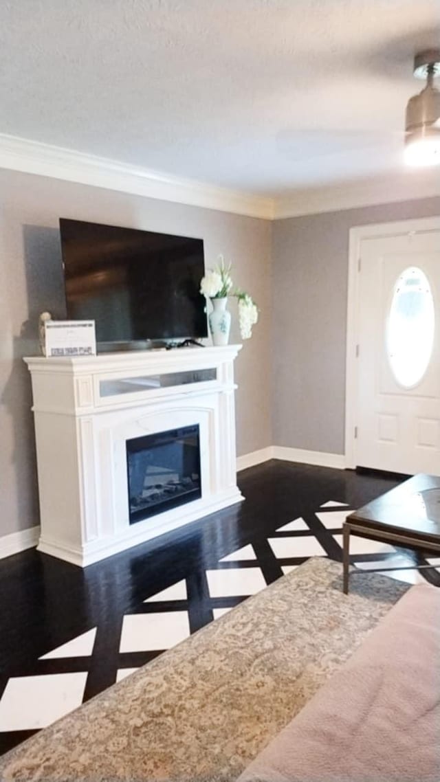 unfurnished living room with dark hardwood / wood-style floors and ornamental molding