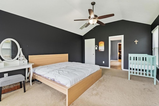 carpeted bedroom with ceiling fan and vaulted ceiling