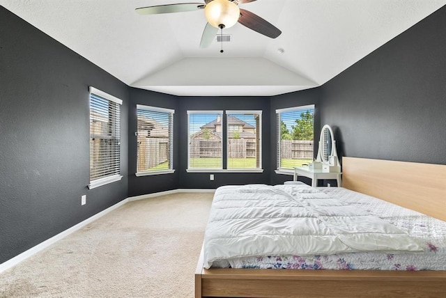 unfurnished bedroom with ceiling fan, carpet floors, and lofted ceiling