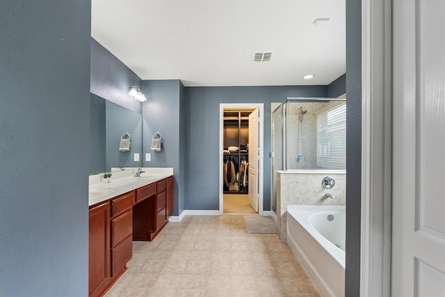 bathroom with vanity and independent shower and bath