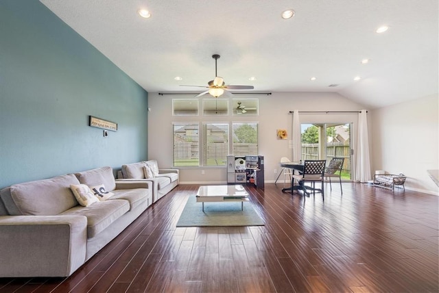 living room with ceiling fan, dark hardwood / wood-style flooring, and lofted ceiling