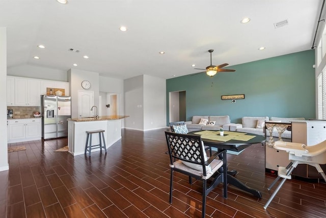 dining space featuring ceiling fan and sink