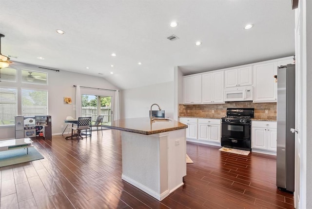 kitchen featuring stainless steel fridge, black range with gas stovetop, a kitchen island with sink, sink, and white cabinetry