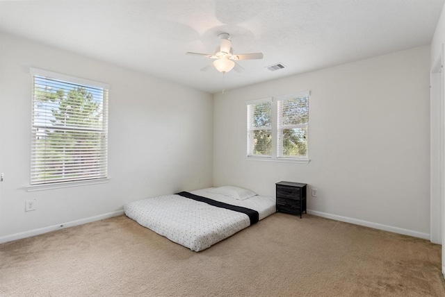 carpeted bedroom featuring ceiling fan