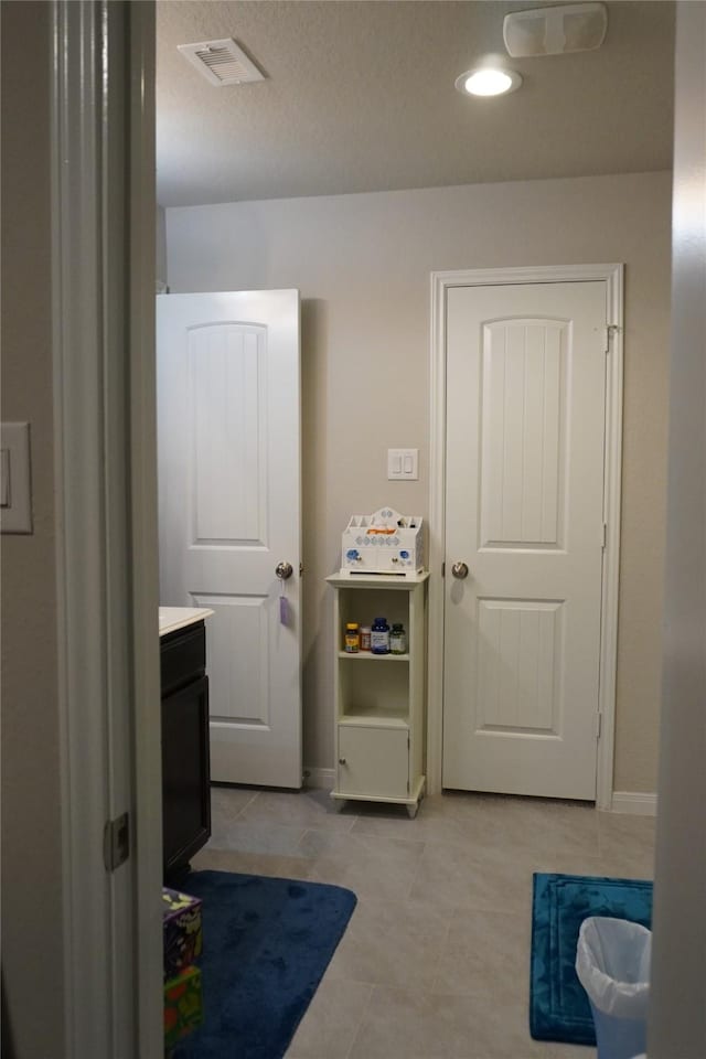 interior space featuring vanity and tile patterned flooring