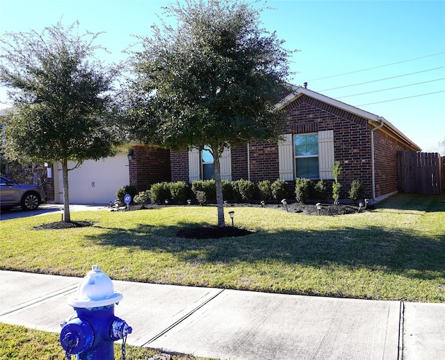 view of front of house with a garage and a front yard