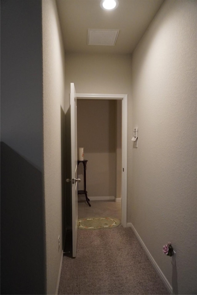 corridor with baseboards, carpet, and visible vents