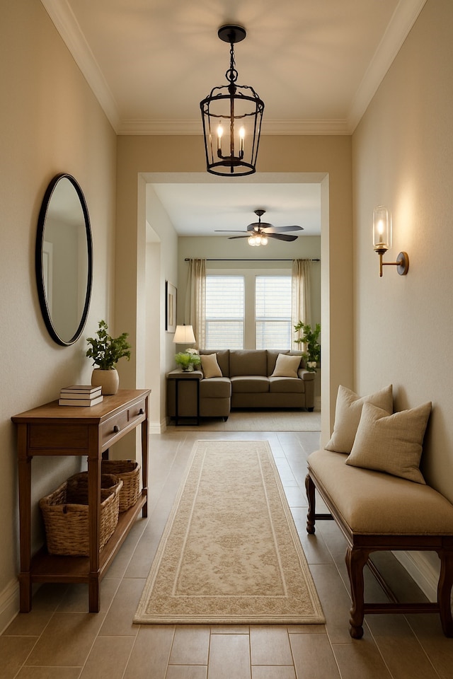 interior space with light tile patterned floors, crown molding, and ceiling fan with notable chandelier