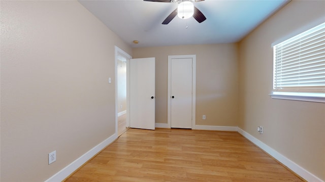 unfurnished bedroom with ceiling fan and light wood-type flooring