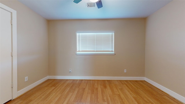 spare room with ceiling fan and light wood-type flooring