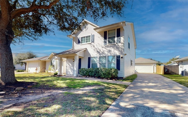 view of front of property with a front lawn, central AC unit, and a garage